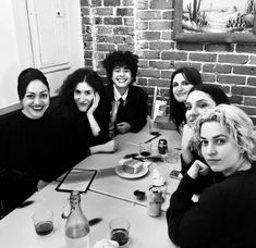 a group of women sitting around a table