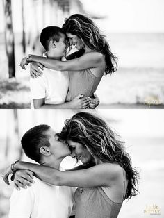 a man and woman kissing on the beach with their arms around each other as if they were in love