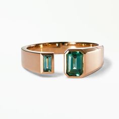 This stunning Dyad band features a 0.60ct emerald cut teal Australian sapphire and a 0.13ct baguette cut teal Australian sapphire, made in recycled 14k yellow gold, by WWAKE Green Sapphire Ring With Baguette Cut, Modern Emerald Ring With Rectangular Stone, Modern Green Sapphire Ring, Modern Rectangular Emerald Ring For May Birthstone, Modern Emerald Cut Emerald Ring, Modern Octagon Emerald Ring, Modern Baguette Cut Emerald Ring, Modern Emerald Cut Emerald Ring With Tension Setting, Modern Baguette Cut Emerald Ring For May Birthstone