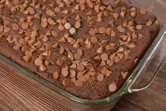 a chocolate dessert in a glass dish on a wooden table