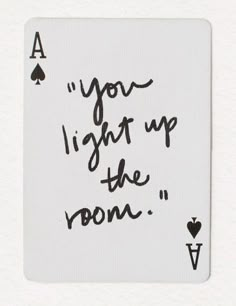 a playing card with the words you light up the room written in black on it