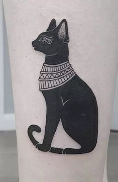 a black cat tattoo on the leg