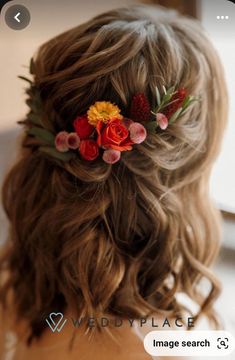 a woman with flowers in her hair is looking at something on the screen that says weddyplace