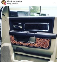 the interior of a vehicle with an intricate leather door handle and dash board cover on it