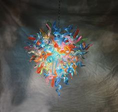 a multicolored light fixture hanging from a ceiling