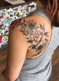 a woman with a flower tattoo on her shoulder