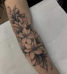 a black and white flower tattoo on the arm