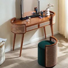 a wooden vanity with a mirror and stool in front of it, next to a window