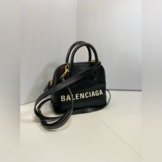 Balenciaga Ville Xxs Handbag Color Black Two Top Handles Adjustable, Detachable Shoulder Strap Dimensions: 8.6"L X 3.1"D X 5.5"H Top Dual Zip Closure One Interior Zip Pocket, One Interior Slip Pocket Protective Metal Feet 100% Calfskin Open To Offers!!!!! Great Condition!! Comes With Straps Bags Balenciaga, Balenciaga Bag, Calf Skin, Balenciaga, Black Color, Zip Pockets, Shoulder Strap, Handles, Bag Lady