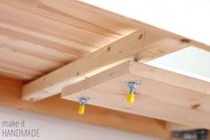 the ceiling is made out of wood and has yellow screws attached to each end