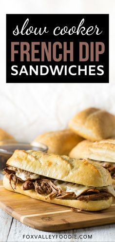 slow cooker french dip sandwiches on a cutting board with text overlay reading slow cooker french dip sandwiches