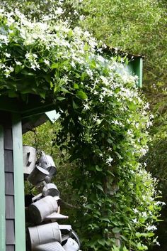 an assortment of pots and pans are stacked on top of each other in the garden