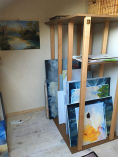 an art studio with paintings on the walls