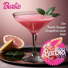 a pink cocktail with grapefruit and mint on the rim