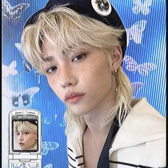 a person with blonde hair and a cell phone