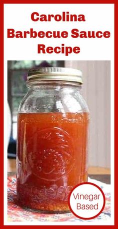 a jar filled with barbecue sauce sitting on top of a table next to a red and white sign