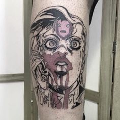 a woman's leg with a tattoo on it that has an image of a clown