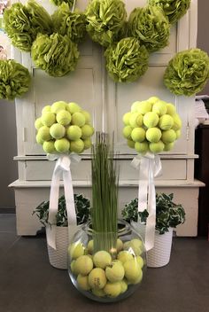 a vase filled with lots of green tennis balls