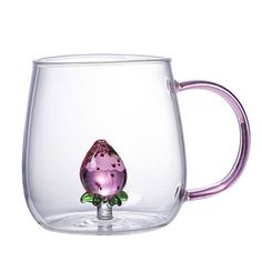 a glass mug with a pink flower on it