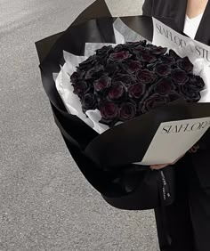 a person holding a bouquet of roses on the street