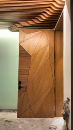 a modern wooden door in the middle of a room