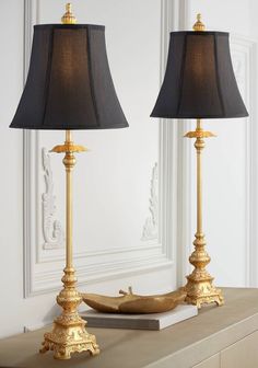 two lamps sitting on top of a table