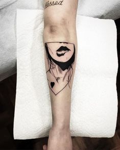 a woman's leg with a tattoo on it that has an image of her face