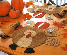 a wooden table topped with turkey shaped place mats