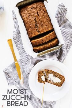 a loaf of bread sitting on top of a white plate next to a knife and fork