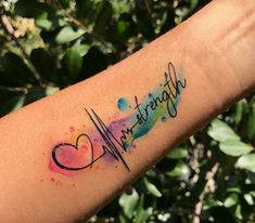 a person's arm with a watercolor tattoo on it that says, strength