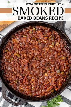 a skillet filled with baked beans on top of a checkered table cloth and text that reads smoked baked beans recipe