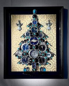 a christmas tree made out of watches and other items is displayed in a shadow box