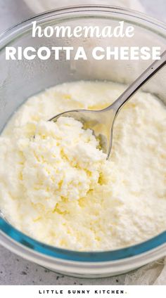 homemade ricotta cheese in a glass bowl with a spoon and text overlay that reads homemade ricotta cheese