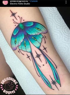 a blue butterfly with stars on its wings is sitting on someone's leg and has the words breathing roots written below it