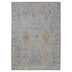 a blue and beige rug with an ornate design on the bottom, in front of a white background