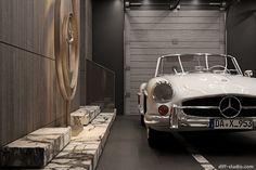 a white car parked in front of a garage door