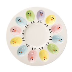 a white plate topped with lots of colorful birds