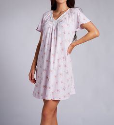 Dreamy floral pattern nightgowns with pretty lace adorning the neck. Deep V-neckline with wide panels of openwork lace set into front. Lace is backed with soft, sheer mesh for comfort. Generous ruching at base of neckline and at top of center back gives gown a fuller fit. Cap-style short raglan sleeves fit loosely around the arm. Straight hem. Relaxed fit. Pullover styling. Lightweight knit cotton is just perfect for warmer temperatures. Carole Hochman Women's Floral Bouquet Flutter Sleeve Short Feminine V-neck Nightgown With Lace Trim, Feminine Floral Print Nightgown For Loungewear, Feminine Floral Print Loungewear Nightgown, Feminine V-neck Nightgown For Spring, Short Sleeve Floral Print Nightgown For Home, Spring V-neck Nightgown With Lace Trim, Feminine V-neck Sleepwear For Sleepover, Spring V-neck Nightgown For Home, Feminine Lace Trim Nightgown For Overnight