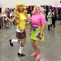 two women dressed in costumes standing next to each other