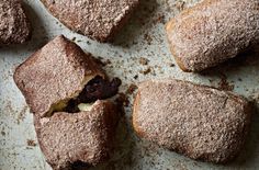 several pastries sitting on top of a pan covered in powdered sugar