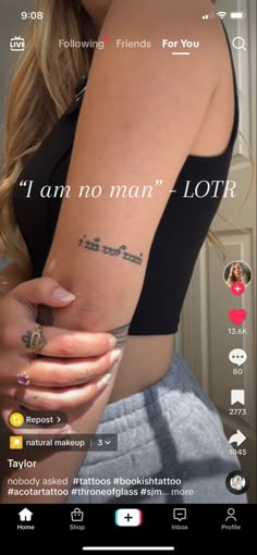 a woman with a tattoo on her arm and the words i am no man lotr