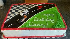 a birthday cake is decorated with racing cars