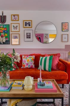 a living room filled with lots of furniture and pictures on the wall above it's coffee table