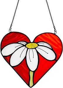 a heart shaped stained glass hanging decoration with a flower on it's center piece