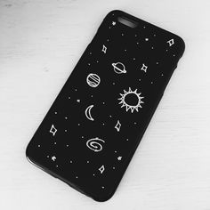 an iphone case with the sun and planets on it, sitting on a white table