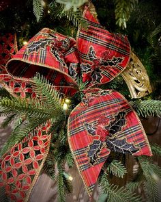 a christmas wreath with red and black plaid bows