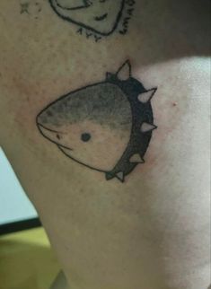 a close up of a person's leg with tattoos on it and an image of a shark