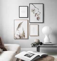 a living room with three pictures on the wall and a coffee table in front of it