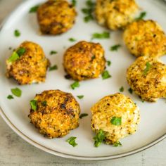 small crab cakes on a white plate with parsley