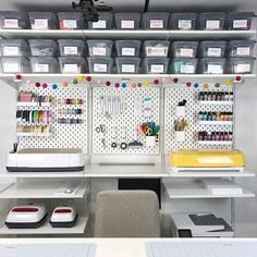 the sewing room is organized with lots of crafting supplies and storage bins on the wall